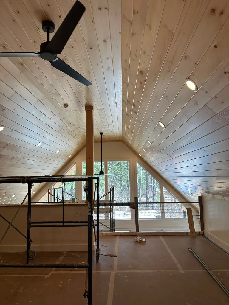 Vaulted pine ceiling with fan