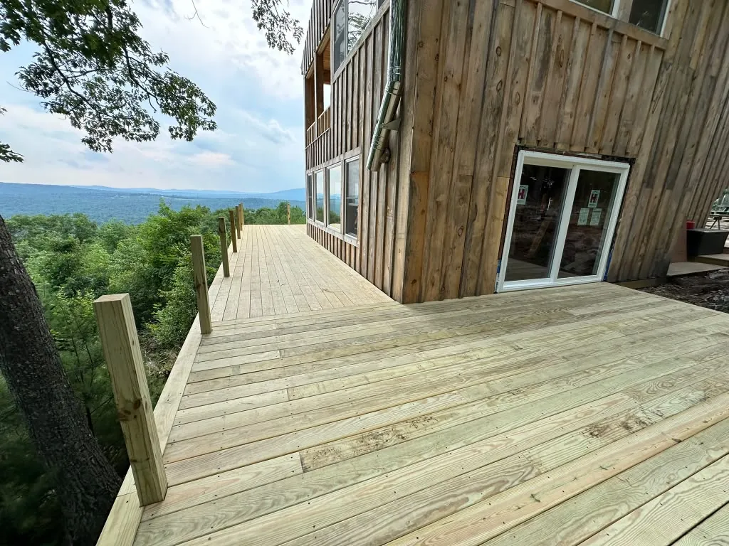 New wood deck with railing posts and mountain view