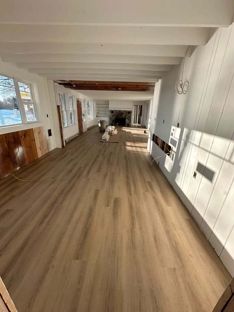 Finished plank flooring through long room